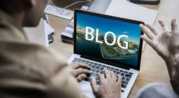 Person learning how to create a blog on a laptop using a blogging platform
